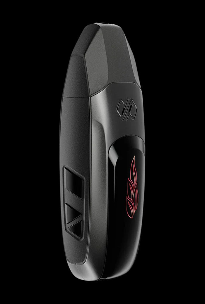 Diagonal close-up of the teal Boundless Vexil Dry Herb Vaporizer against a black background, showing its matte body, triangular side buttons, and red leaf logo.
