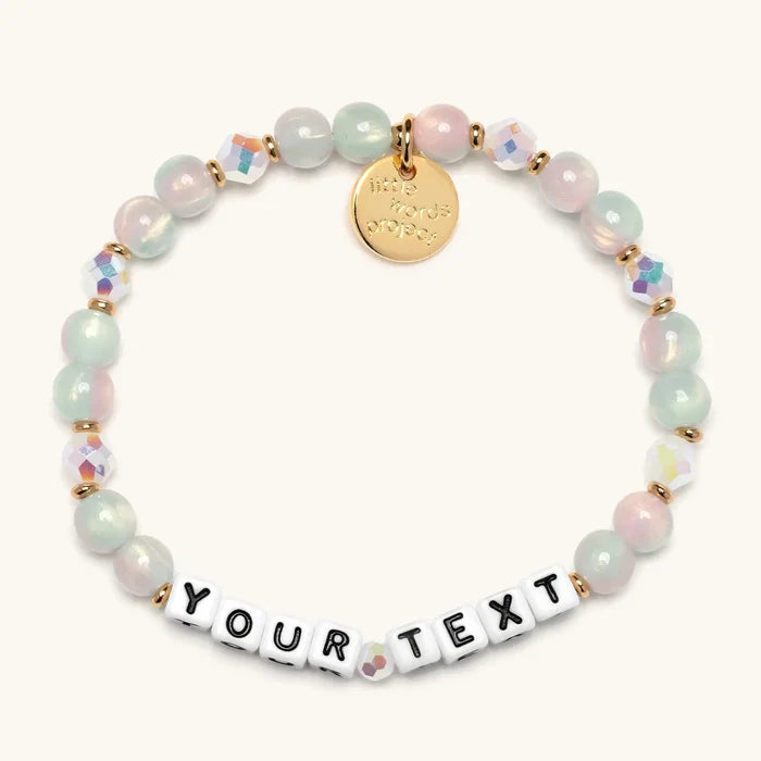 Personalized beaded bracelet with 'YOUR TEXT' on a white background