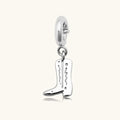 Silver cowboy boot charm pendant with engraved detailing and a spring-ring clasp, shown on a white background.