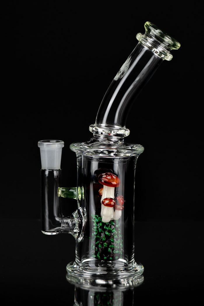 Clear glass water pipe (rig) with colorful mushroom-shaped glass inserts, against a black background.