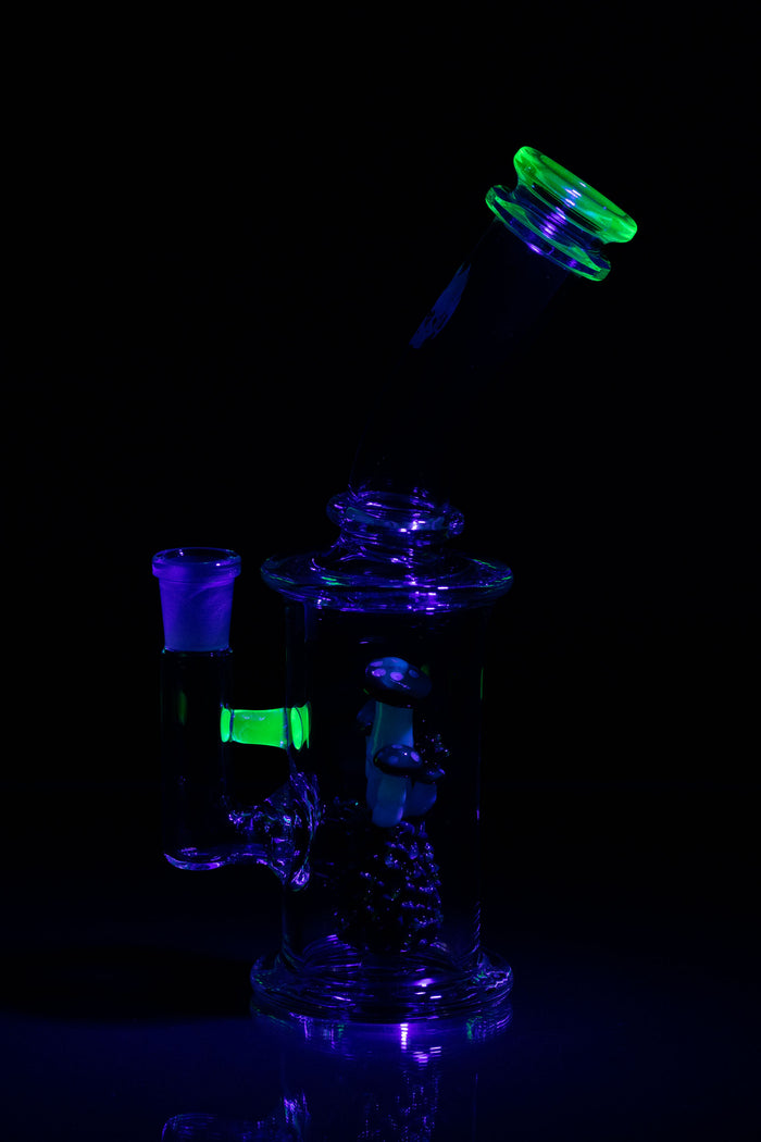 Glowing glass rig with disassembled parts on a black background.
