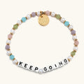 Multicolored beaded bracelet with 'KEEP GOING' message on a white background