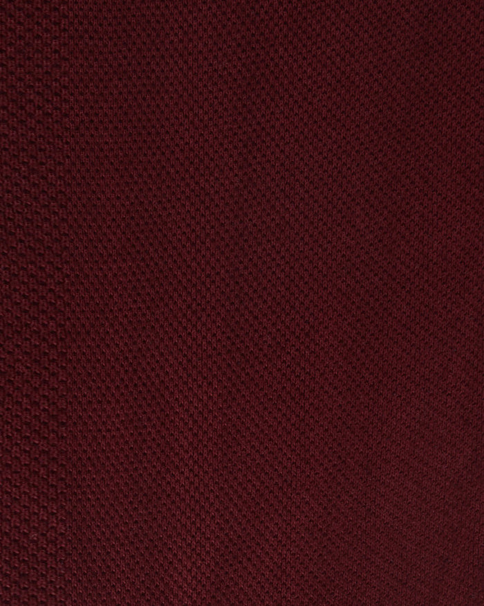 Close up of the custom oxford polo shirt for men by Luxire in maroon