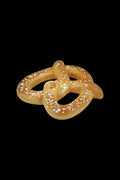 Front view of the Roast & Toast Hot & Salty Pretzel Pipe, a tan-colored, looped smoking device against a plain white background.