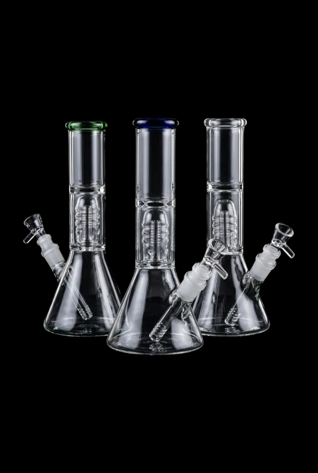 Front-facing trio of clear glass Stack​ed Showerhead Perc Beaker Bong pieces on a black background, each with a colored rim and visible percolator.
