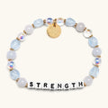 Bracelet with beads and letter tiles spelling 'STRENGTH' on a white background