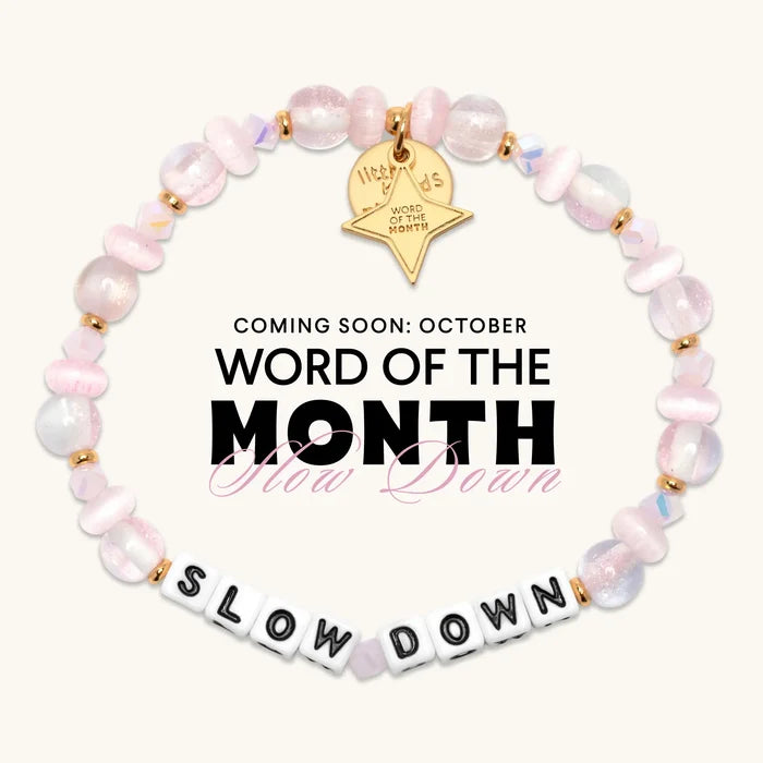 Coming soon, the Slow Down October Word of the Month bracelet with white letter beads, iridescent pink and pearl beads, and a gold Word of the Month star charm
